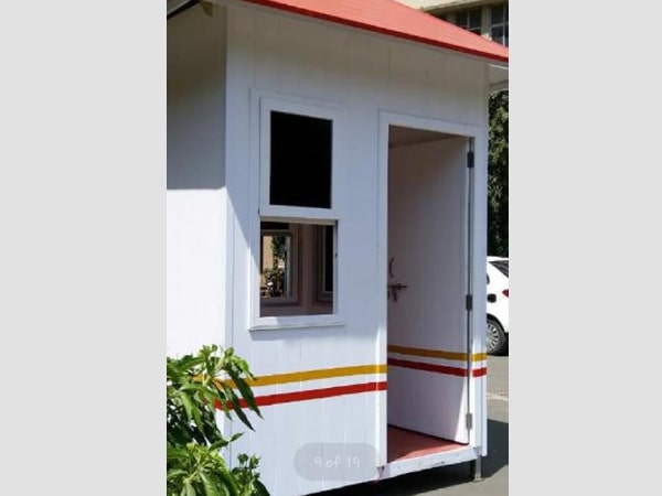 A small white uPVC security cabin