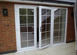 White UPVC French doors with a grid pattern on a brick wall.