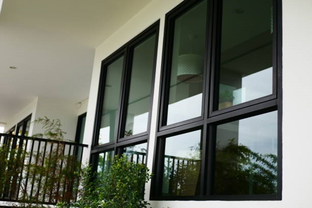 Modern black-framed windows with large glass panels, providing a sleek and contemporary look for residential or commercial spaces.